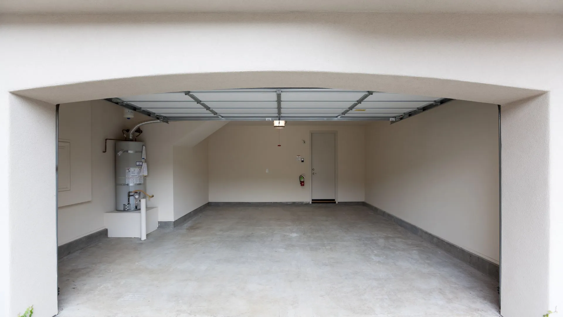 Open garage door leading into a clean garage